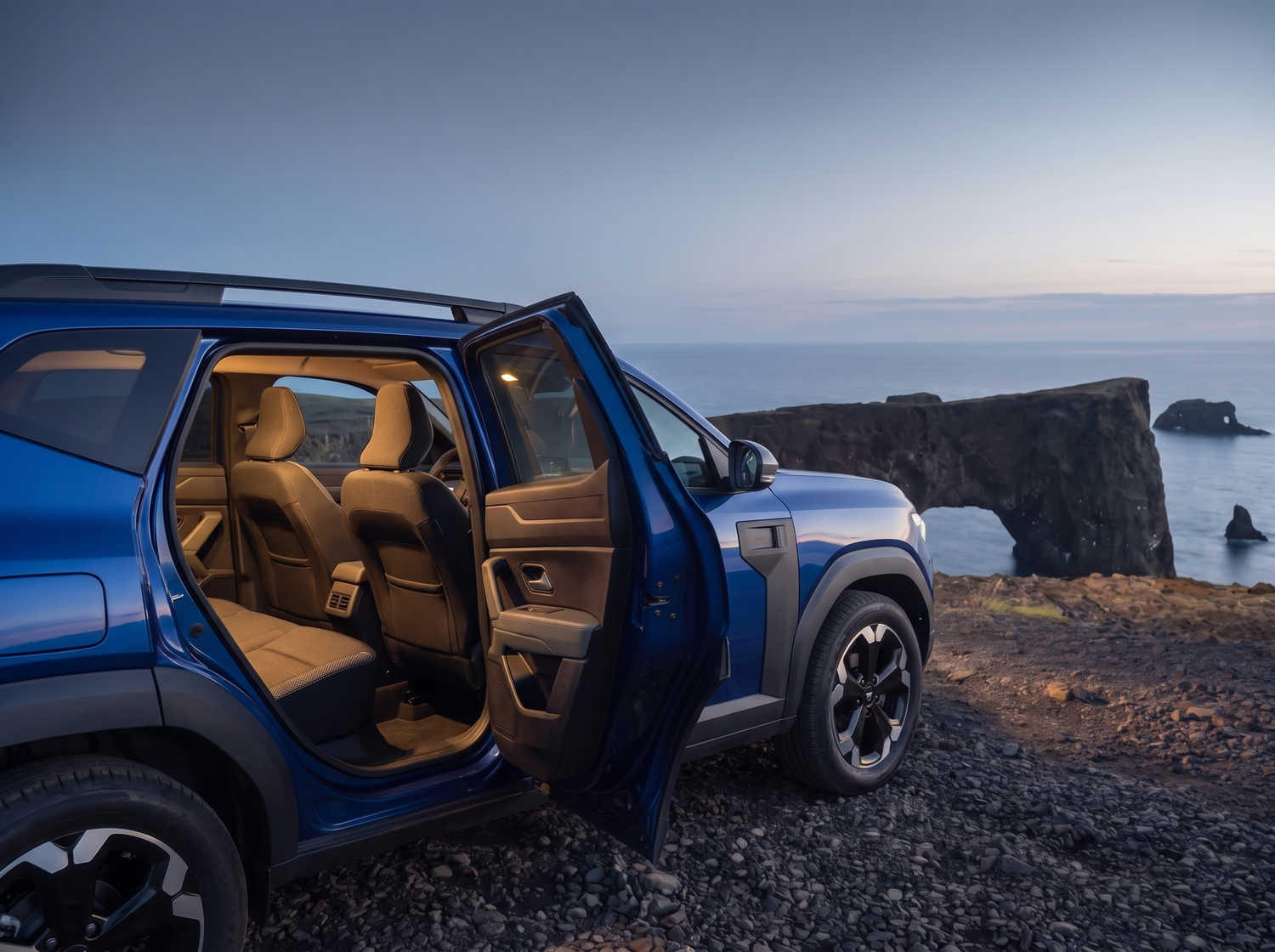 Dacia Bigster bleu avec boîte manuelle et transmission intégrale, 5 places et capacité pour 4 bagages, conçu pour les routes accidentées d’Islande avec confort.