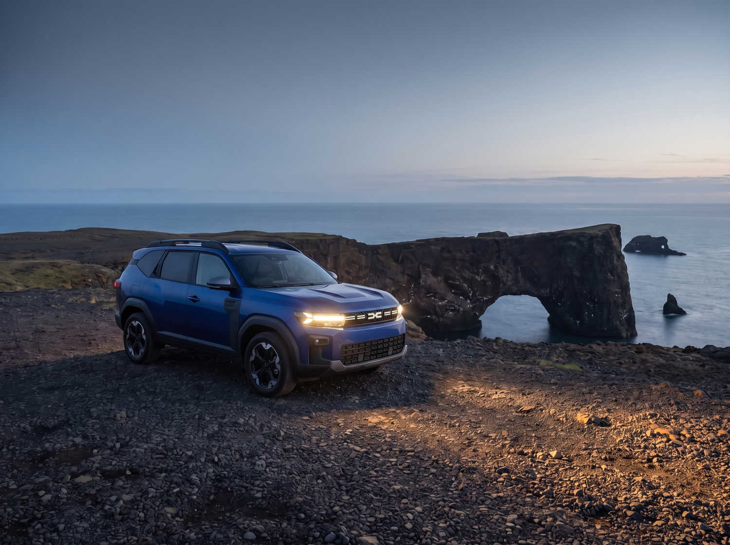 Dacia Bigster bleu avec boîte manuelle et transmission intégrale, 5 places et capacité pour 4 bagages, conçu pour les routes accidentées d’Islande avec confort.